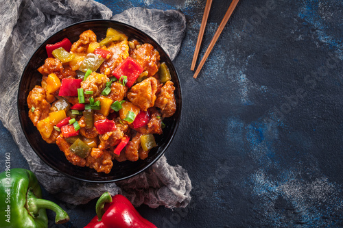 Sweet and sour chicken with colorful bell pepper on a plate