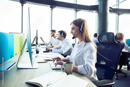 Female customer support operator with headset and smiling