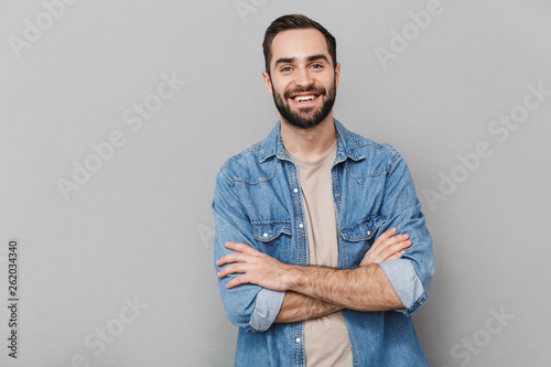 Excited cheerful man wearing shirt standing isolated