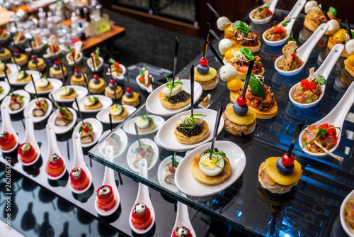 buffet table with cold appetizers and aperitifs with fish and caviar