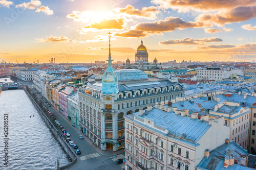 Department store shop class luxury, near the Red Bridge, historical buildings of Saint-Petersburg. In the background the city and St. Isaac's Cathedral dome of golden color, in the evening at sunset.