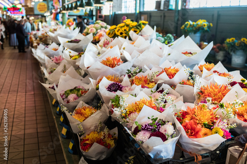 Bouquets of varied flowers in a stand at the Pike Place Market in Seattle