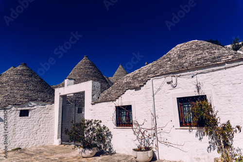 Houses of the tourist and famous Italian city of Alberobello, with its typical white walls and trulli conical roofs.