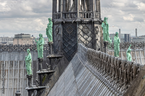 Paris, France - March 15, 2018: Detail of The spire of Notre Dame Cathedral with Archangel Gabriel in the foreground. Behind, around the spire, the bronze figures of the apostles and the evangelists.