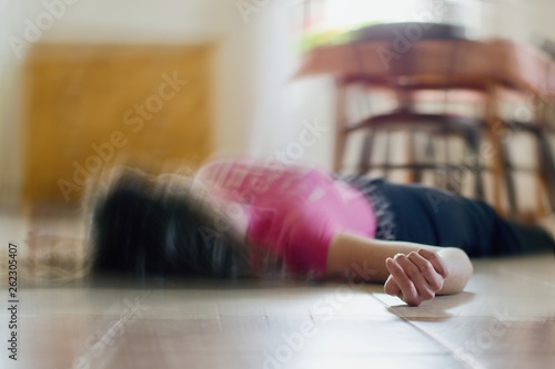 Woman lying on the floor at home, epilepsy, unconsciousness, faint, stroke, accident or other health problem.