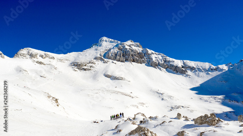 Panoramic drone view of mountain's peak covered by snow