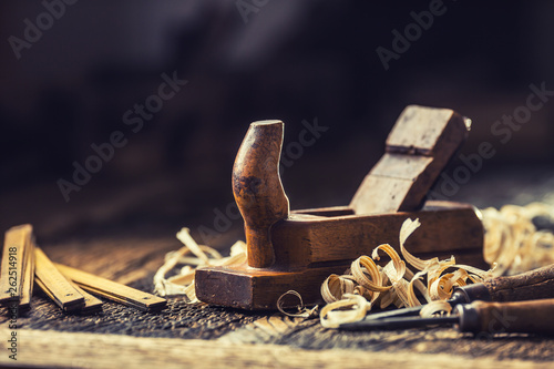 Old planer and other vintage carpenter tools in a carpentry workshop