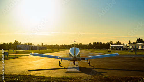 Small plane ready to take off at sunrise.