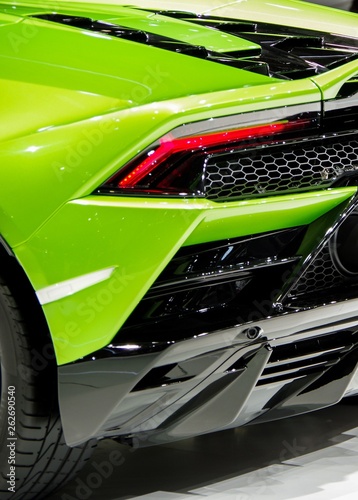 Green shiny modern sports car body tail light and carbon fiber components