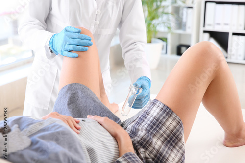 Gynecologist examining pregnant woman in clinic