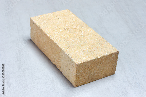 refractory brick for masonry fireplaces and stoves on grey background close-up