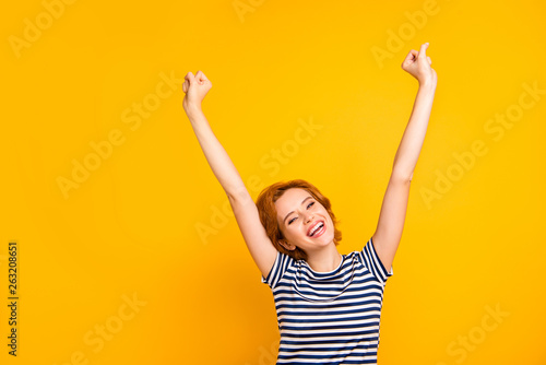 Close up photo beautiful amazing yelling she her lady mouth opened delighted hands arms raised up air best win wear casual striped white blue t-shirt outfit clothes isolated yellow bright background