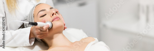 Beautiful woman in professional beauty salon during photo rejuvenation procedure