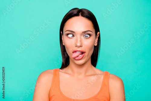 Close up photo portrait of funny funky playing fool making faces she her girl sticking tongue out watching in different ways isolated pastel background