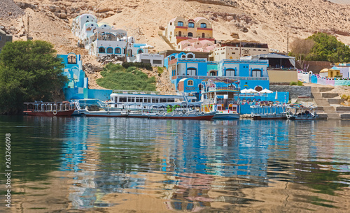 View of river nile in Aswan Egypt with traditional Nubian village on riverbank