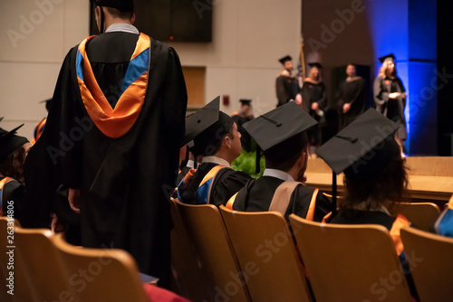 College graduates attend the commencement ceremony marking the end of their educations