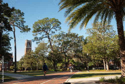 Students at the University of Florida walk through Plaza of the Americas with Century Tower in the background.