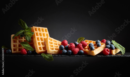 Waffles with blueberries, raspberries and fresh mint.