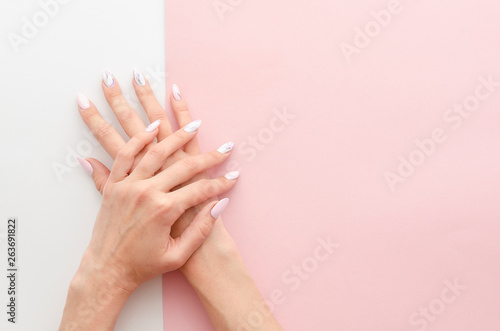 Top view woman's hands manicure with nail painting work. Drawing on nails banner concept for a beauty salon with copy space