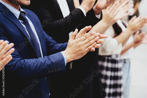 Group of businessmen are clapping their hands to congratulate the project, the work being done according to the goal set. Good work requires teamwork. Glad to receive additional salary