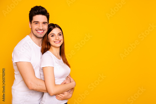 Profile side view portrait of two nice attractive lovely sweet charming cheerful cheery people enjoying spending time isolated over vivid shine bright yellow background