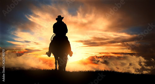 Cowboy on a horse at sunset