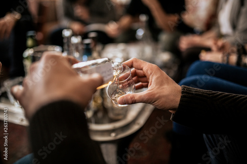 A close up shot of a man pouring whisky from a samlping bottle. Concept of fine alcohol, tasting of Japanese whisky. Master class and degustation.