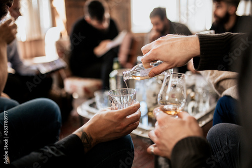 A group of people tasting Japanese whisky. Concept of fine alcohol. Master class and degustation of whisky.