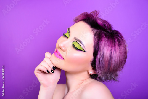 Sexy girl with short hair. Portrait of a woman with bright colored hair, all shades of purple. Beautiful lips and makeup. Professional coloring. professional makeup.
