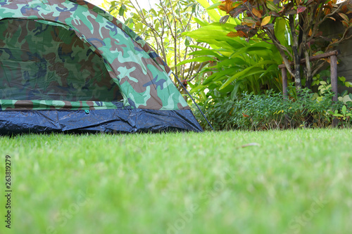 tent camping on green grass field campground, equipment for trip backpack journey travel in nature