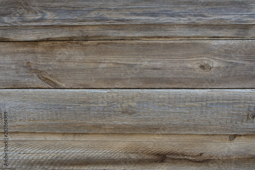 The texture of weathered wooden wall. Aged wooden plank fence of horizontal flat boards.