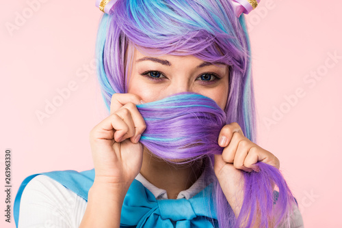 Asian anime girl covering face with hair isolated on pink