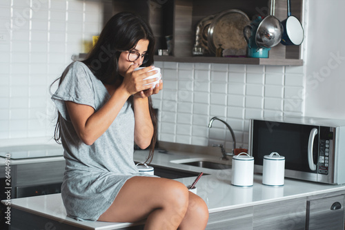 young woman drinking coffee at home