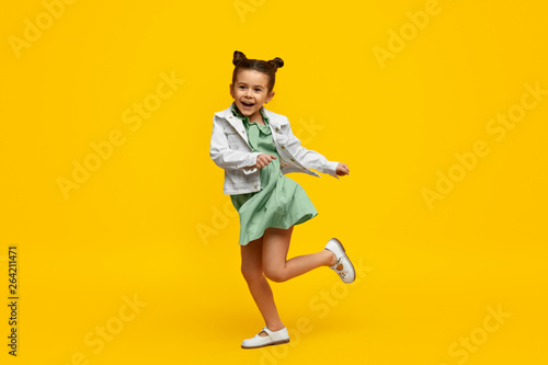 Stylish child smiling and dancing