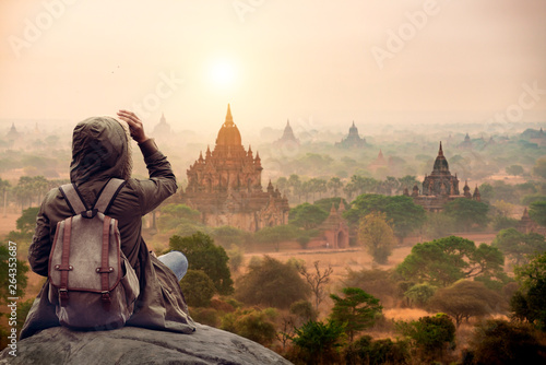 The tourist sitting watching Bagan pagoda landscape view during sunrise and the ancient pagoda in Bagan,Mandalay Myanmar