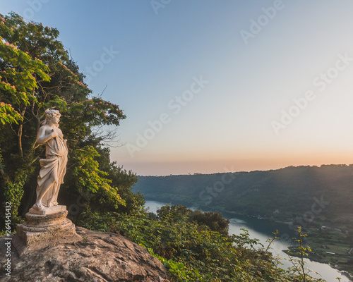 View of Lake Nemi and hills with statue on rock, from Nemi, Italy