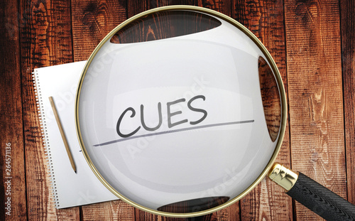 Study, learn and explore cues - pictured as a magnifying glass enlarging word cues, symbolizes analyzing, inspecting and researching the meaning of cues, 3d illustration