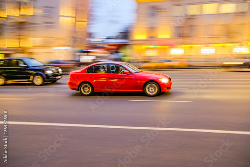 Car at high speed with a blurred image on the background of the city in the dark
