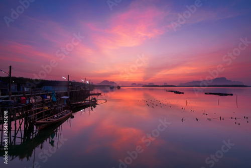 Beautiful sky at fsherman village during sunrise and fisherman longtail boats