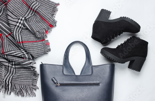 Women's clothes, shoes and accessories on a white background. Suede boots, bag, scarf. Flat lay