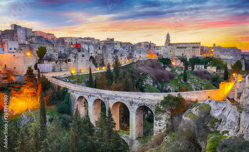 Gravina in Puglia ancient town, bridge and canyon at sunrise. Panoramic view of old city Gravina in Puglia, Apulia, Italy. Europe