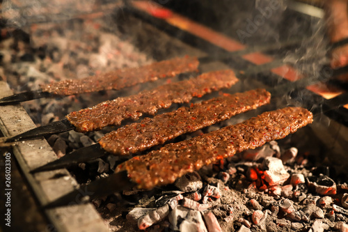 Traditional oriental Adana kebap and shashlik skewer with tomato and flatbread