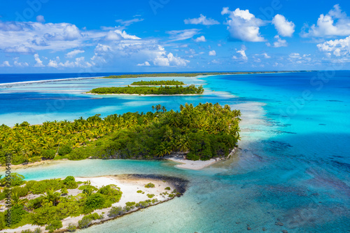 Drone aerial video of Rangiroa atoll island motu and coral reef in French Polynesia, Tahiti. Amazing nature landscape with blue lagoon and Pacific Ocean. Tropical travel paradise in Tuamotus Islands.