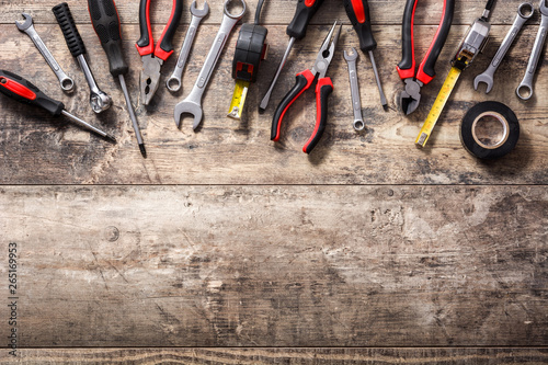 Building tools repair set on wooden background. Top view. Copyspace