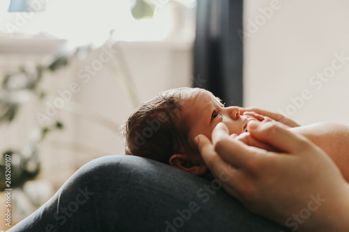 the child lies on his mother's lap