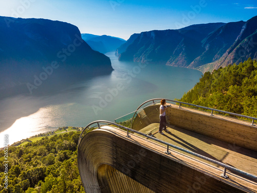 Tourist enjoying fjord view on Stegastein viewpoint Norway