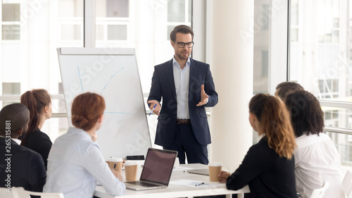 Male business coach speaker in suit give flipchart presentation