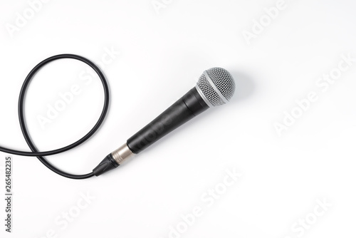 Microphone on white background with clipping path . Close up of dynamic microphone connect with male xlr connector and cable isolated on white background,top view.
