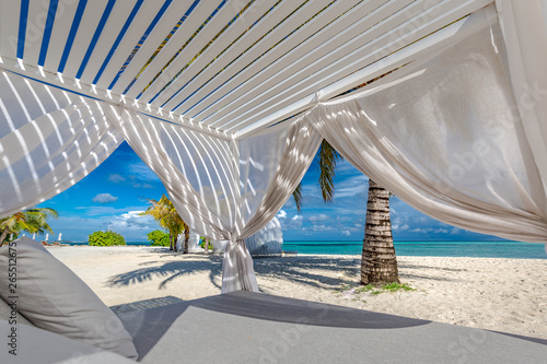 White beach canopies. Luxury beach tents at a resort. Wonderful view of beach scenery, luxury vacation and travel background concept