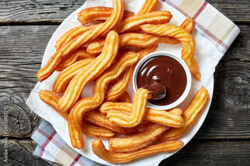 close-up of churros on plate with chocolate sauce